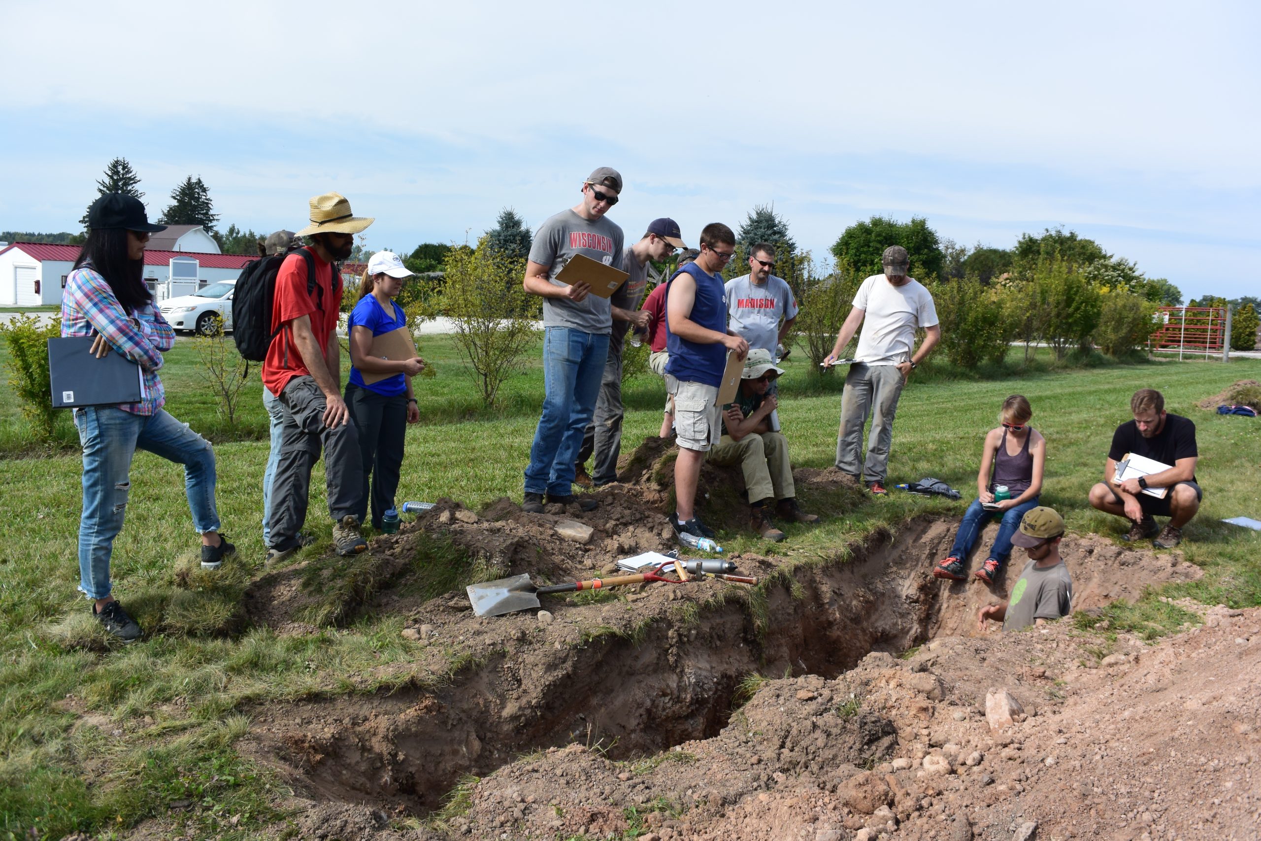 Individuals working in a soil pit. The overlay text is clickable and will take you to the Foundation donation page for the Champ Tanner Agricultural Physics Award Fund.