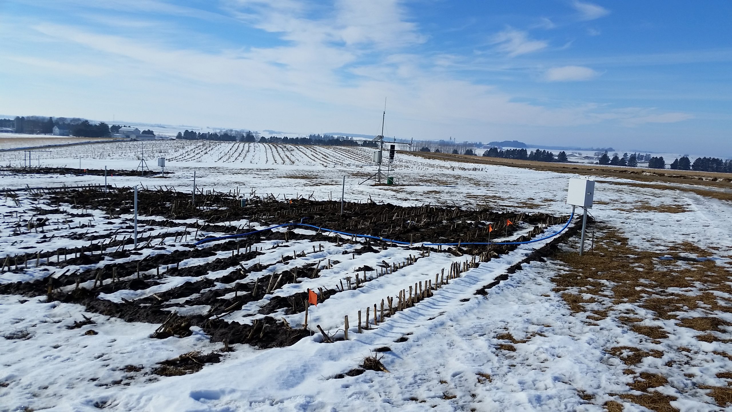 Agricultural field lighted covered in snow. The overlay text is clickable and will take you to the the Research pages for the Soil Physics and Soil and Water Management faculty members.